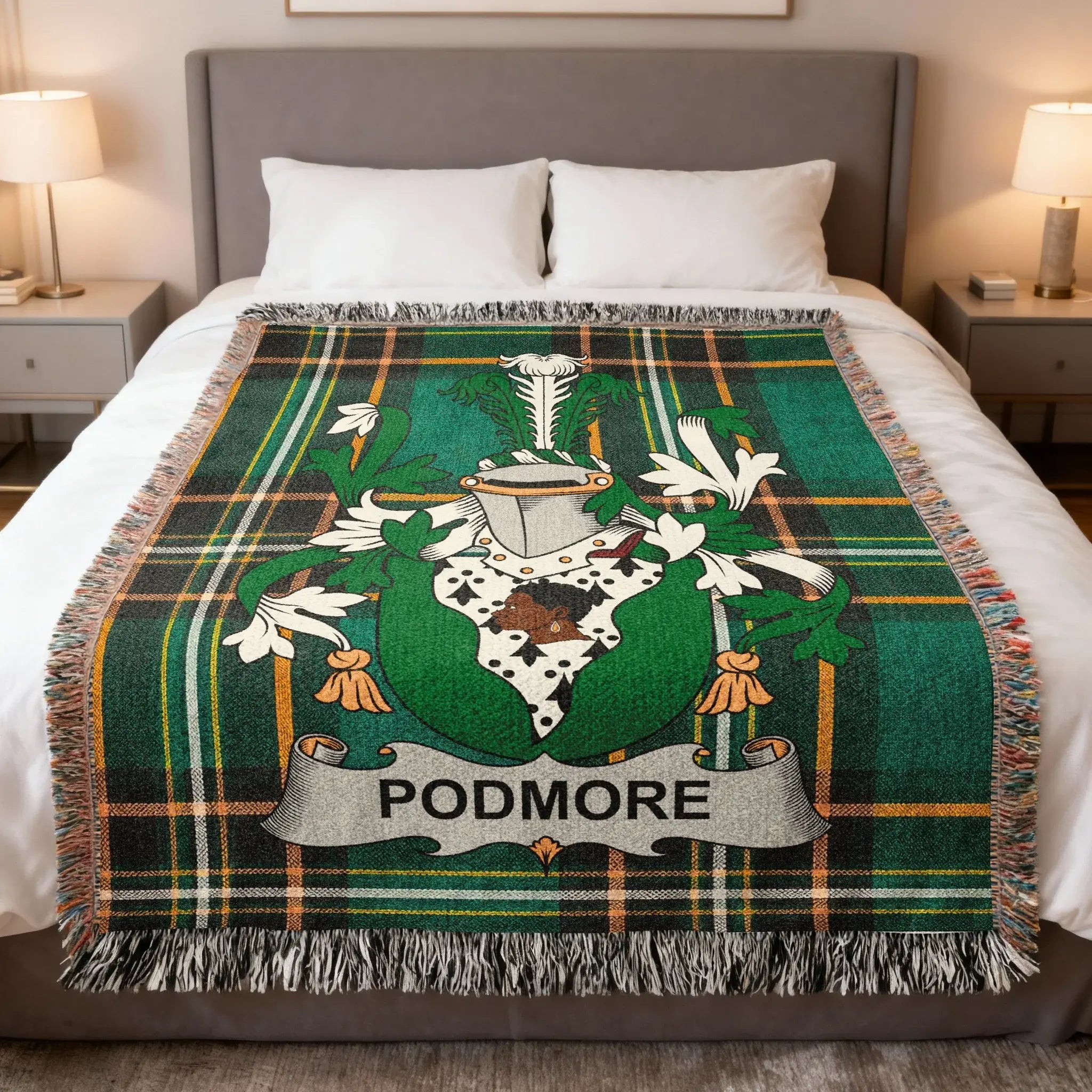 Green plaid blanket with Podmore family crest on a bed.