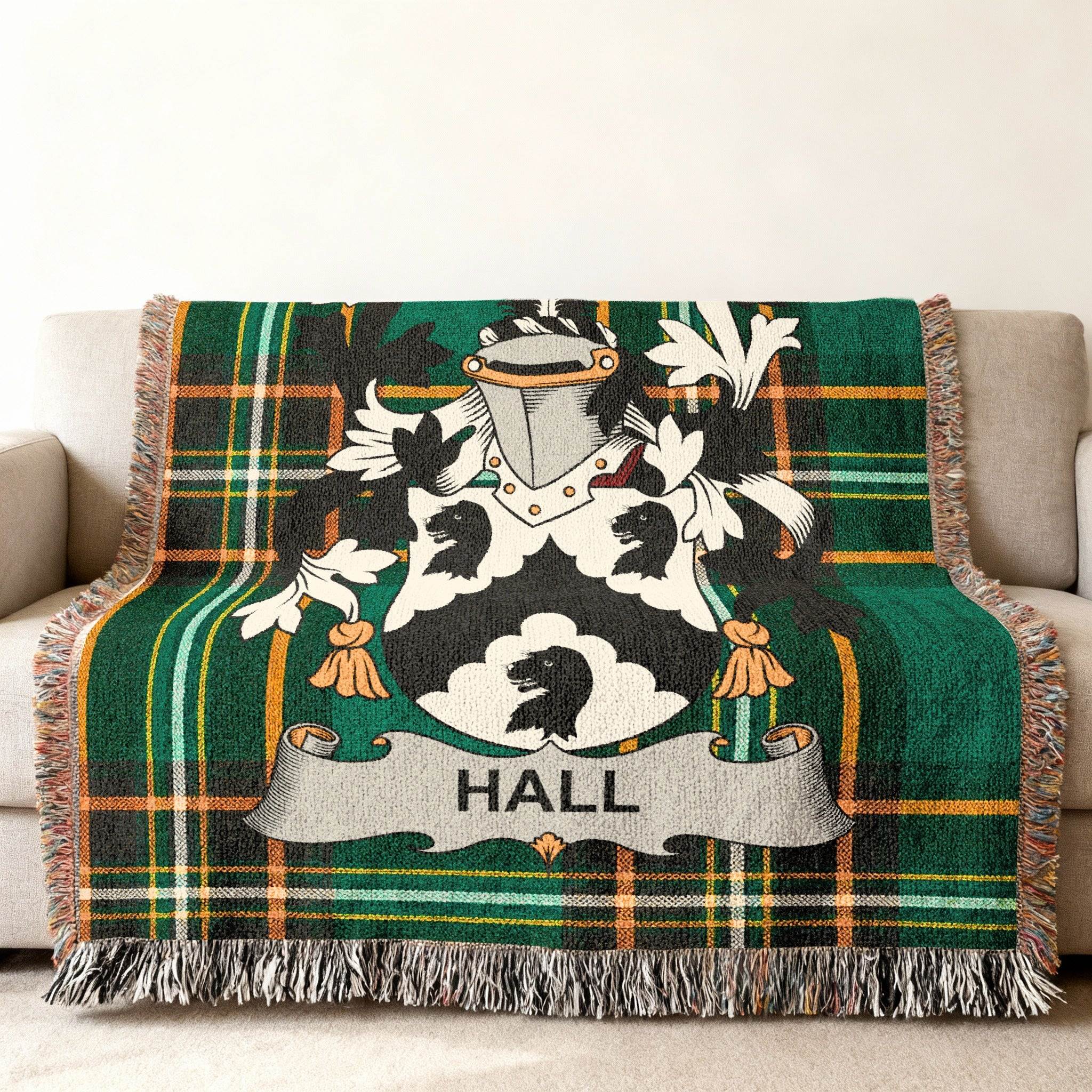 Green plaid blanket with a Hall family crest featuring a black bear.