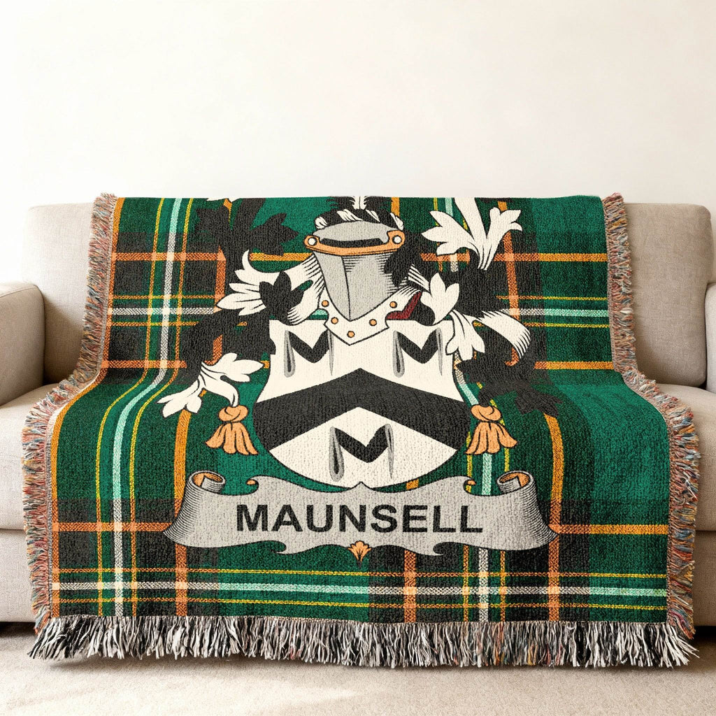 Green tartan throw blanket with Maunsell coat of arms draped over a sofa.