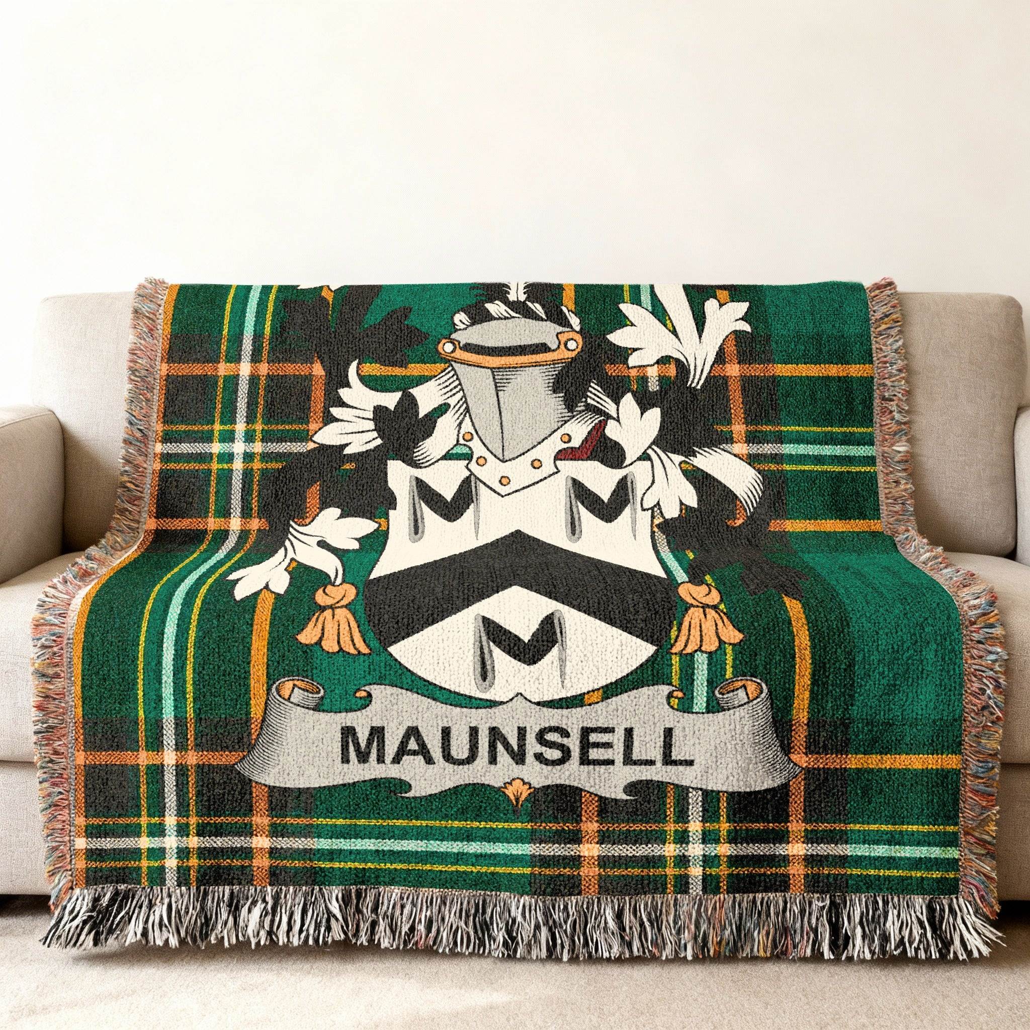 Green tartan throw blanket with Maunsell coat of arms draped over a sofa.