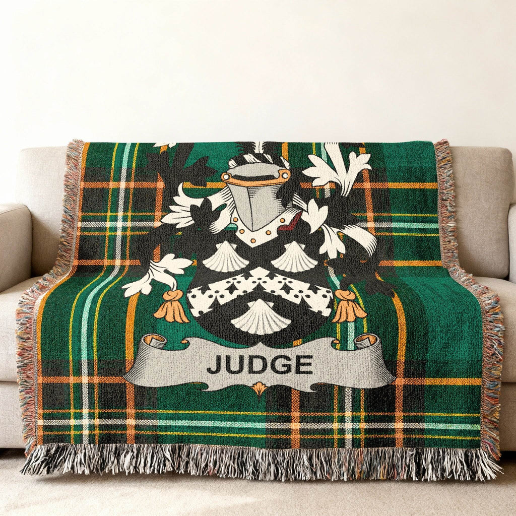 Tartan blanket with the JUDGE coat of arms draped on a sofa.