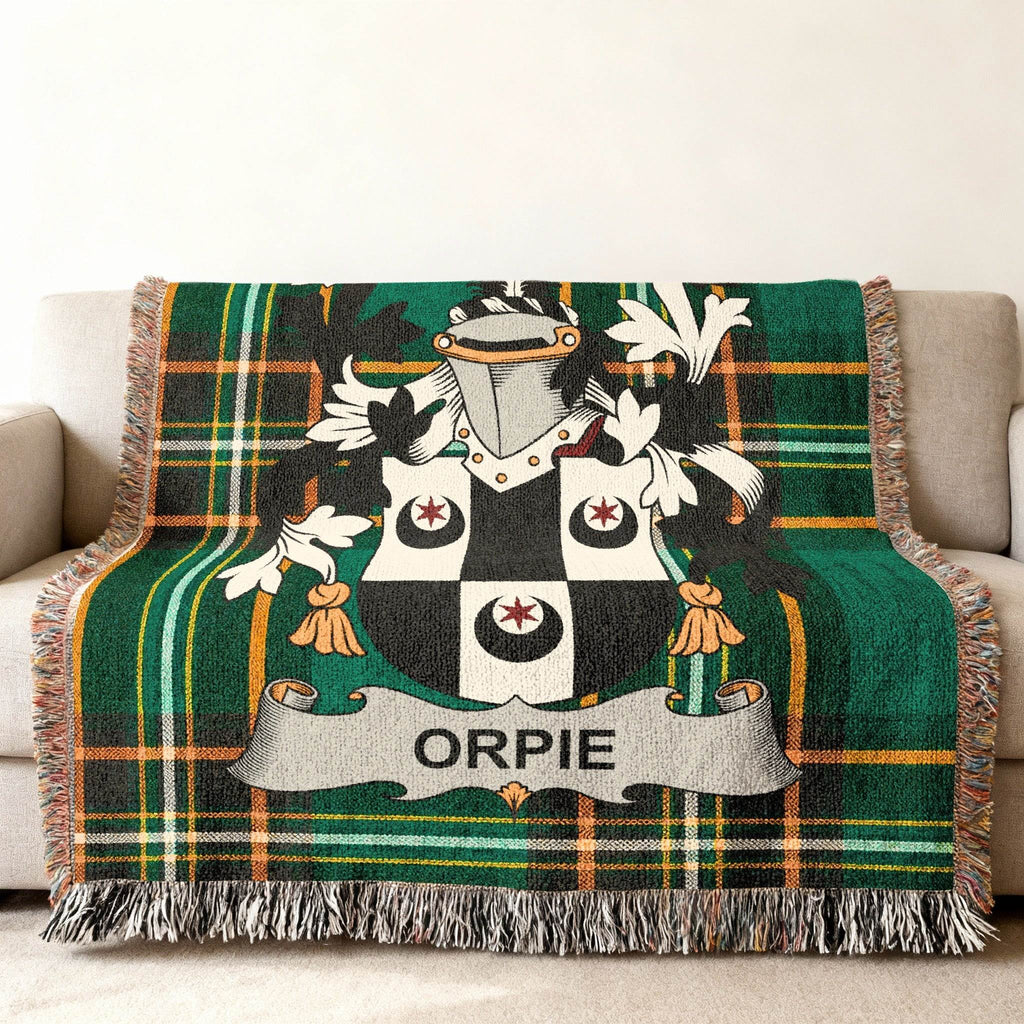 Green plaid throw blanket with Orpie family crest displayed centrally.
