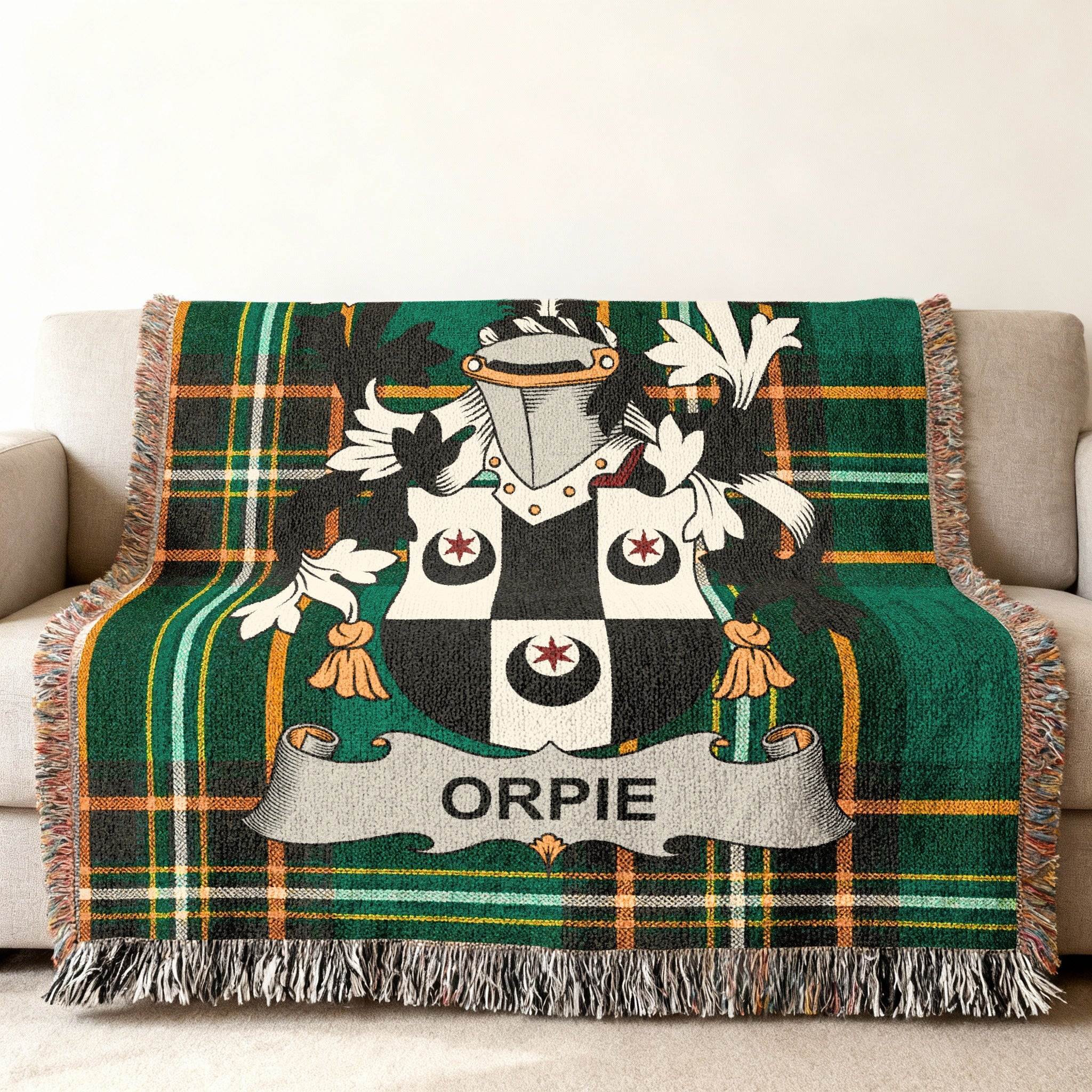 Green plaid throw blanket with Orpie family crest displayed centrally.
