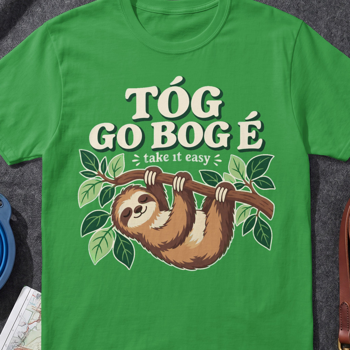 Tóg Go Bog É Take It Easy Sloth funny Irish T-shirt in Irish Green, flat-lay mockup