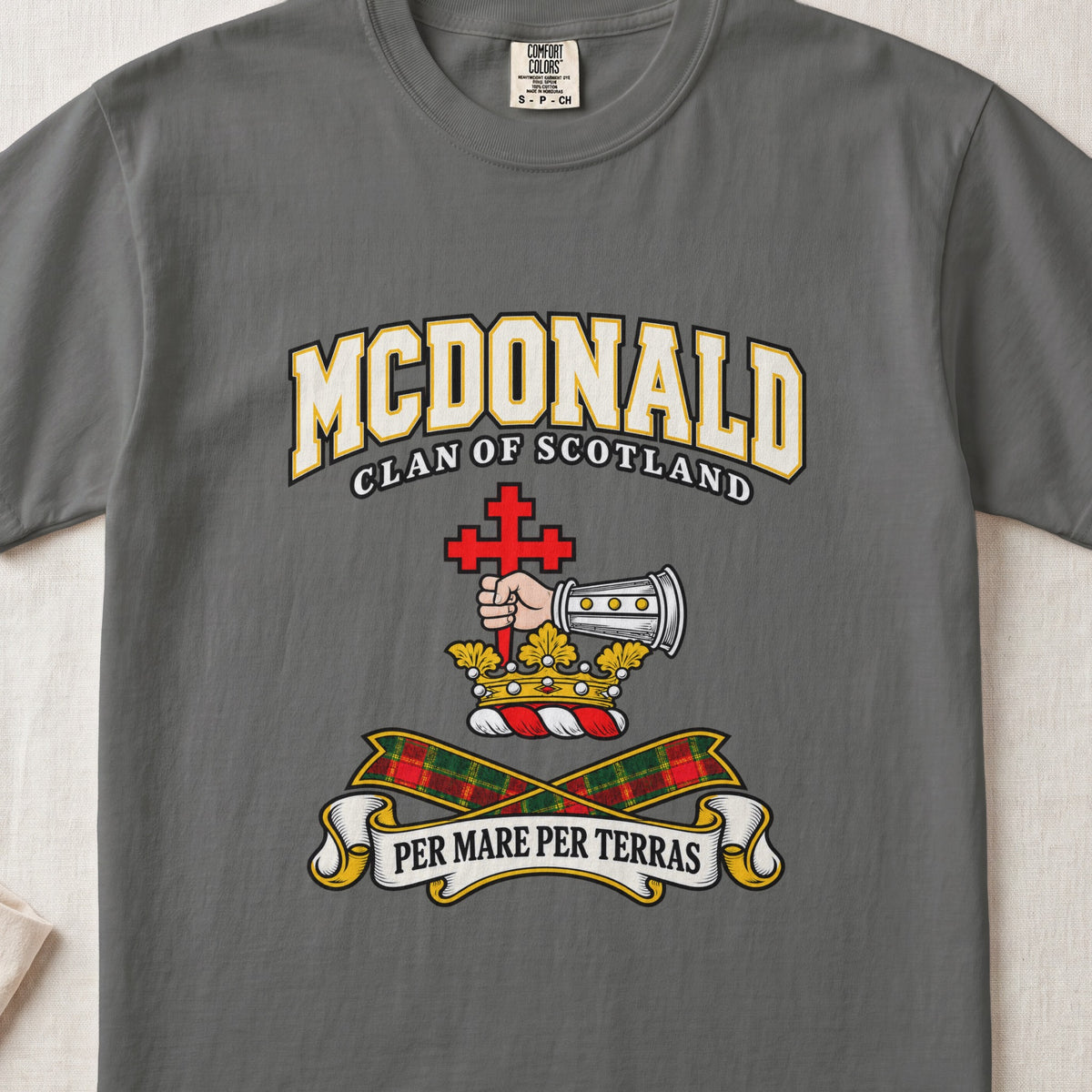 McDonald graphic T-shirt in Pepper gray, front flat lay showing varsity lettering and armoured forearm with hand holding red cross.