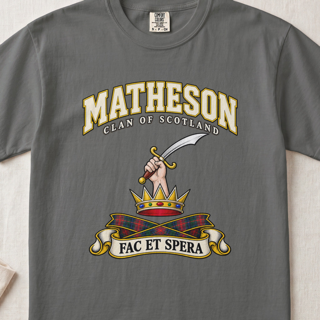 Matheson Scottish clan T-shirt in Pepper, front view with a hand holding a curved sword above a gold crown and motto banner.
