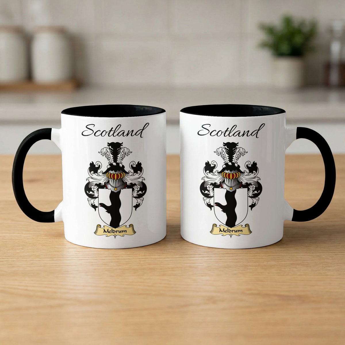 Pair of black-accent Meldrum Scottish coat of arms mugs showing the family design printed on both sides