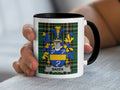 White mug with black rim featuring a family crest with the name "BAKER".