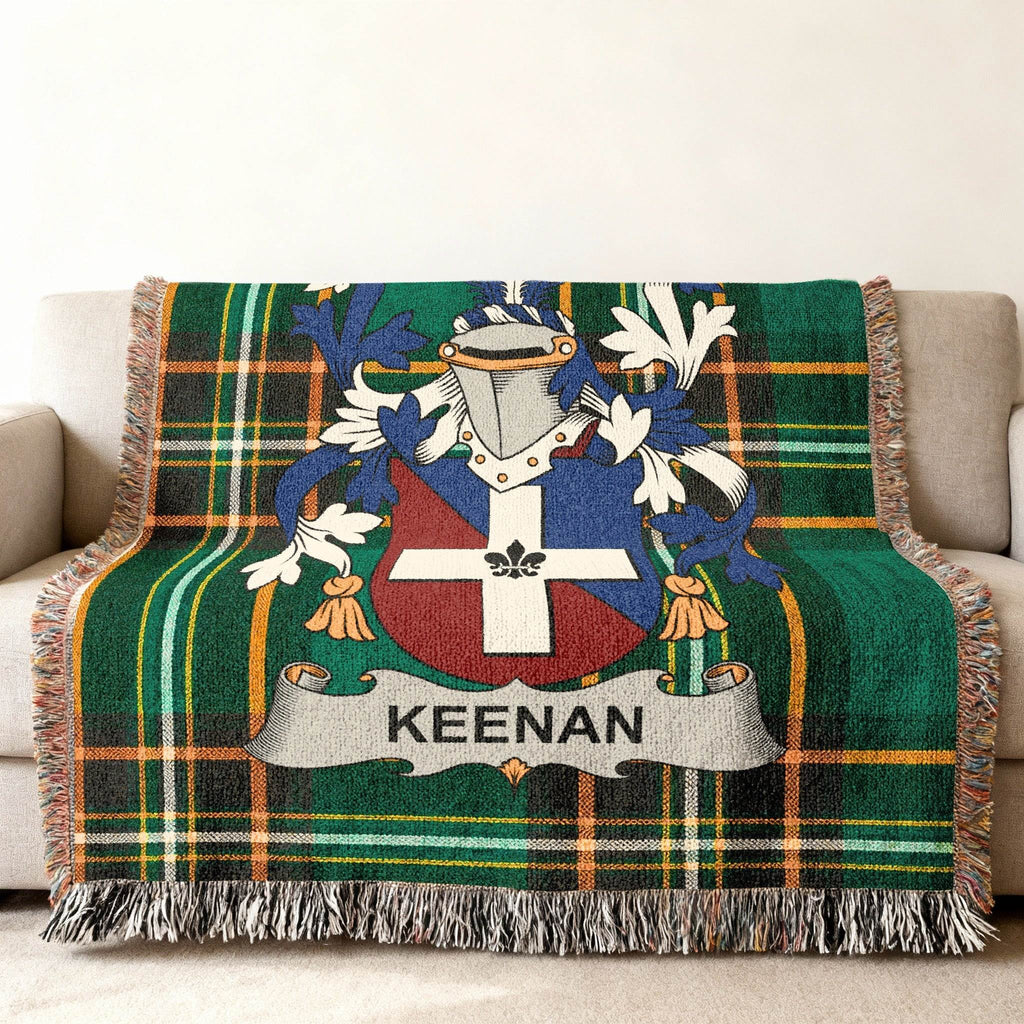 Green plaid throw blanket with Keenan family crest displayed prominently.
