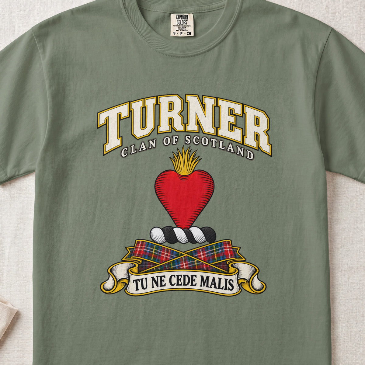 Turner Scottish clan T-shirt in Moss, front view with a red heart topped with golden flames and motto banner.