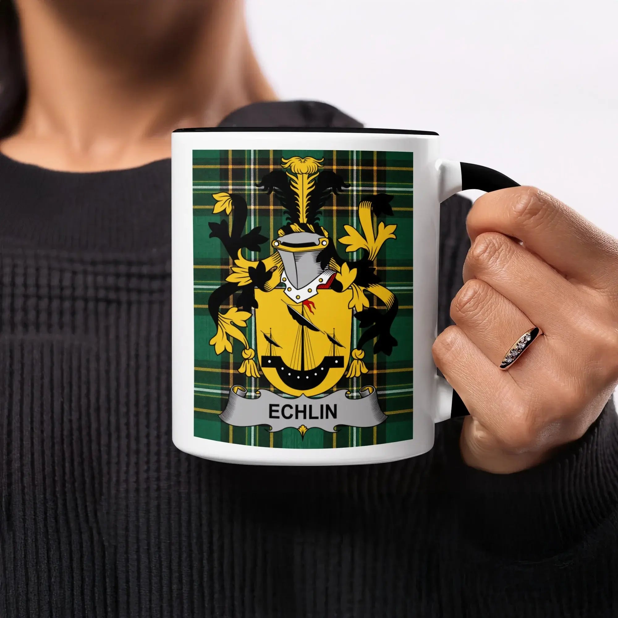 White mug with black handle featuring the "Echlin" coat of arms on a green tartan background.
