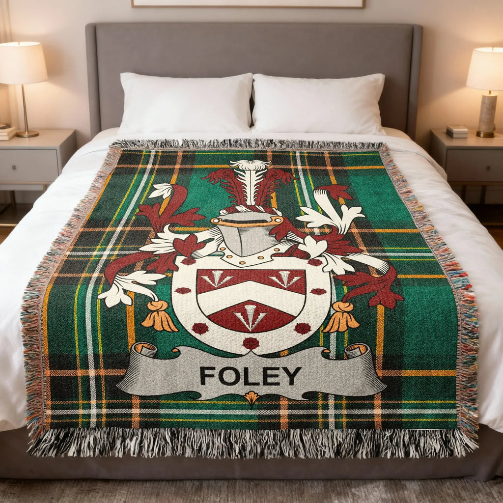 Foley family crest on a green plaid woven blanket draped on a bed.