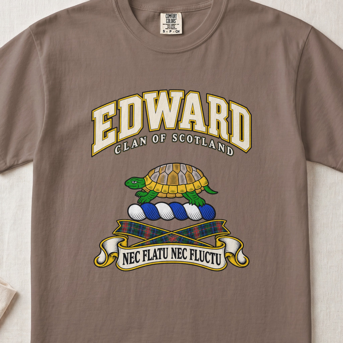Edward Scottish clan T-shirt in Espresso, front view with a green and gold tortoise and motto design.