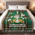 Green plaid throw blanket with Shaughnessy crest and lions.