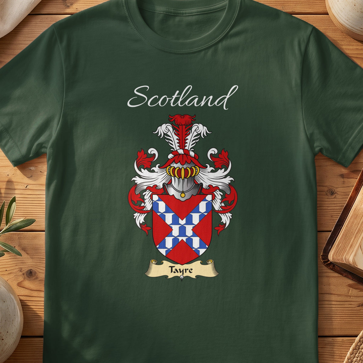 Forest Green Tayre Scottish T-shirt laid flat with coat of arms artwork and “Scotland” text.