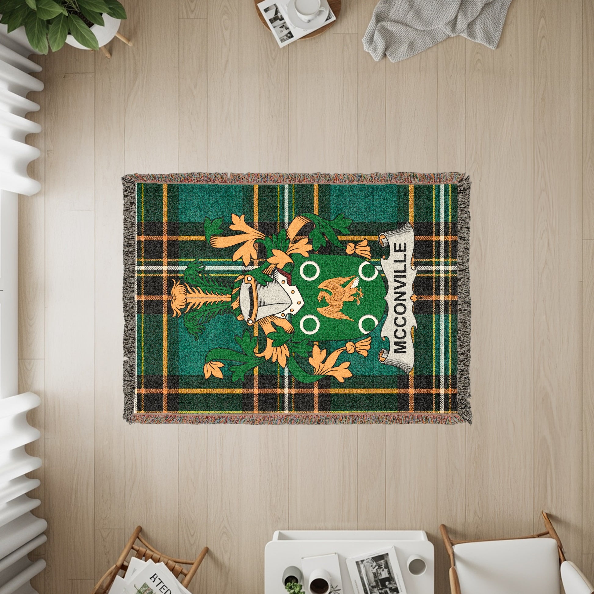 Green and orange plaid throw with McCORVILLET crest and fringe.