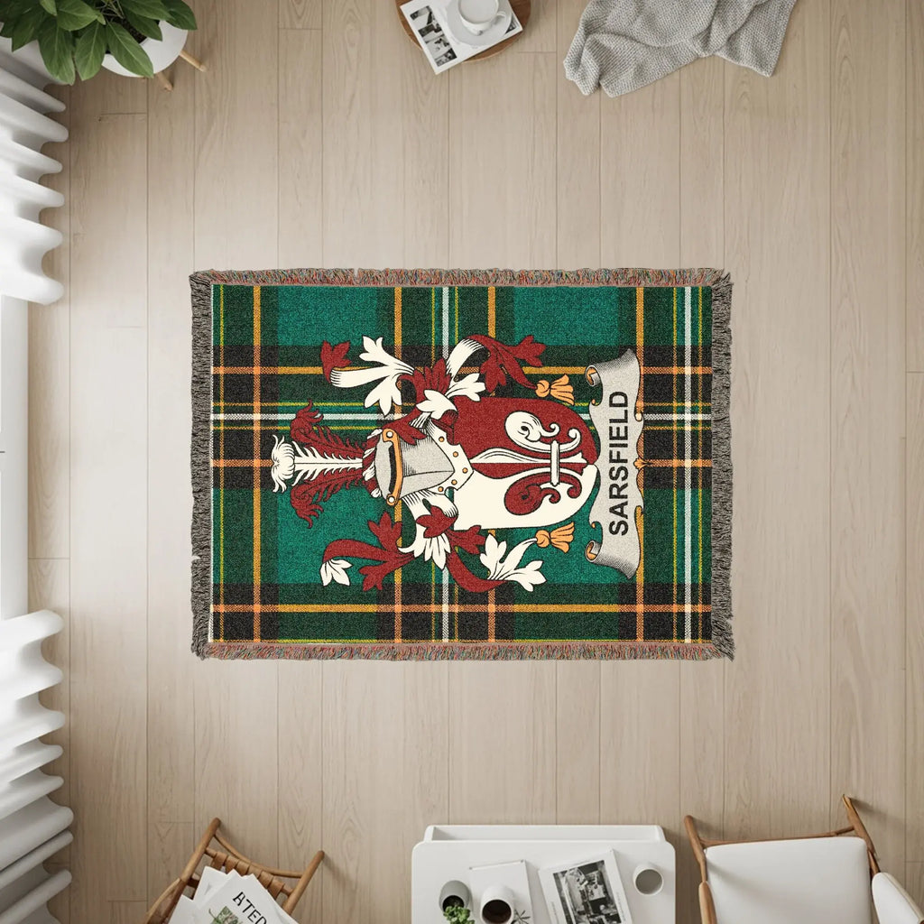 Sarsfield family crest on a green plaid woven throw blanket.