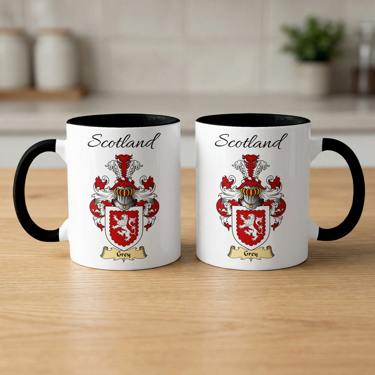 Pair of black-accent Grey mugs showing the double-sided Scottish family shield design on white ceramic.