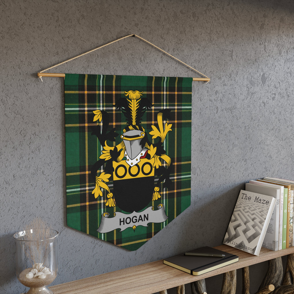 Hogan family crest on a green plaid pennant banner hanging on a textured wall.