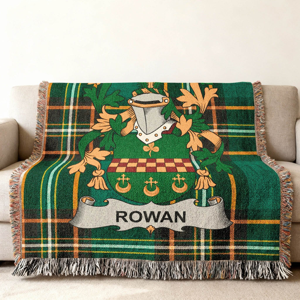 Green plaid throw blanket with a coat of arms bearing the name "Rowan".
