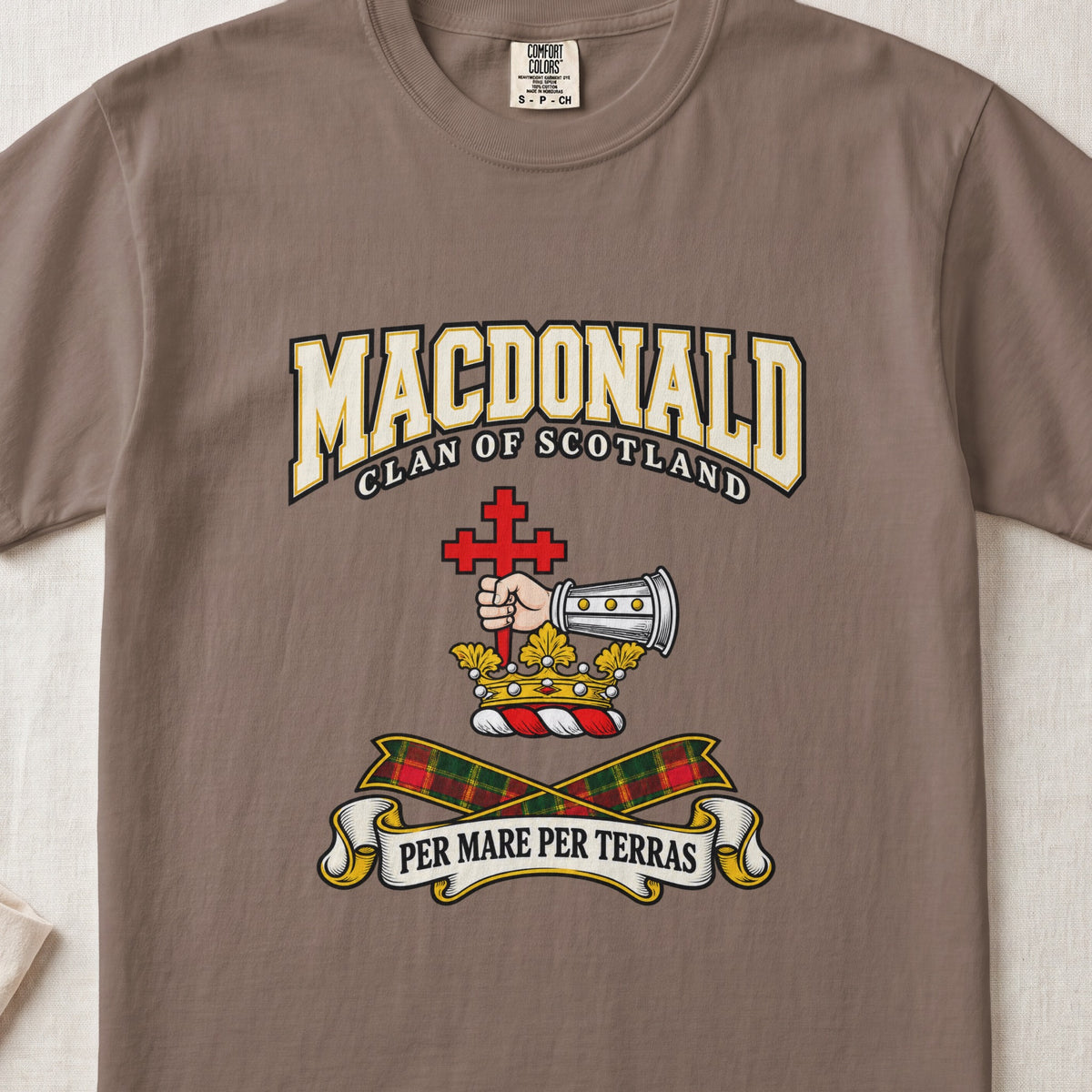MacDonald graphic T-shirt in Espresso brown, front flat lay showing varsity lettering and armoured forearm with hand holding red cross.