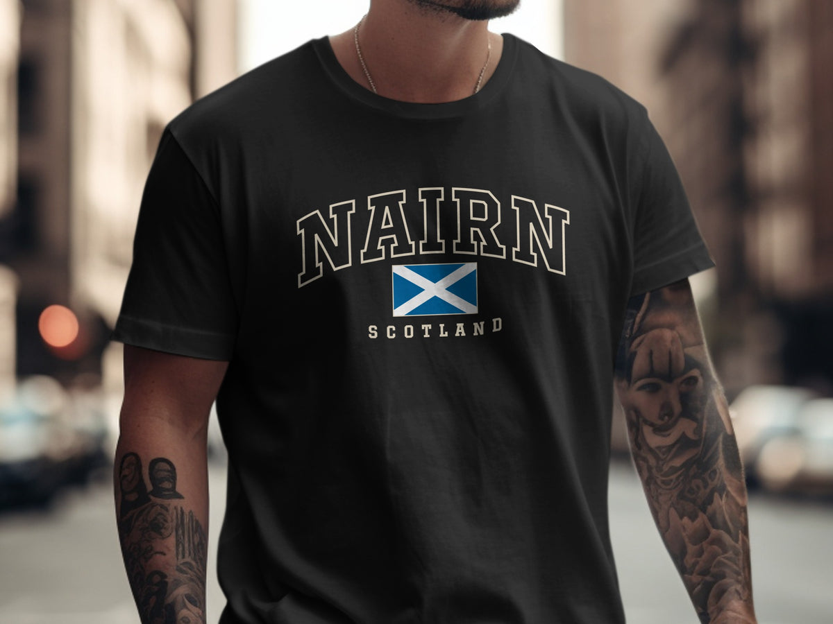 Model wearing the Black Nairn Scotland Comfort Colors T-shirt with the Scottish Saltire