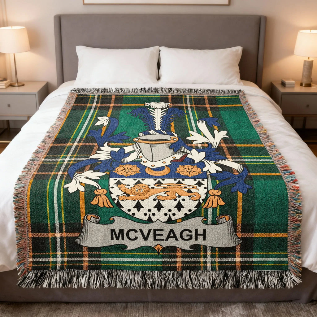 McVEAGH family crest on a green tartan blanket with fringe.