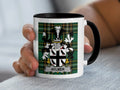 White mug with black rim featuring Aylmer family crest on tartan background.