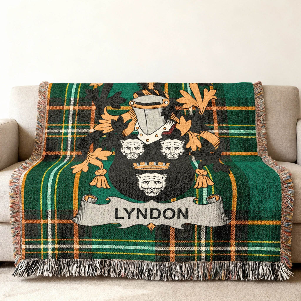 Green plaid throw blanket with the Lyndon family crest in the center.