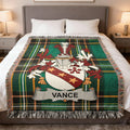 Vance family crest on a green tartan plaid woven throw blanket.