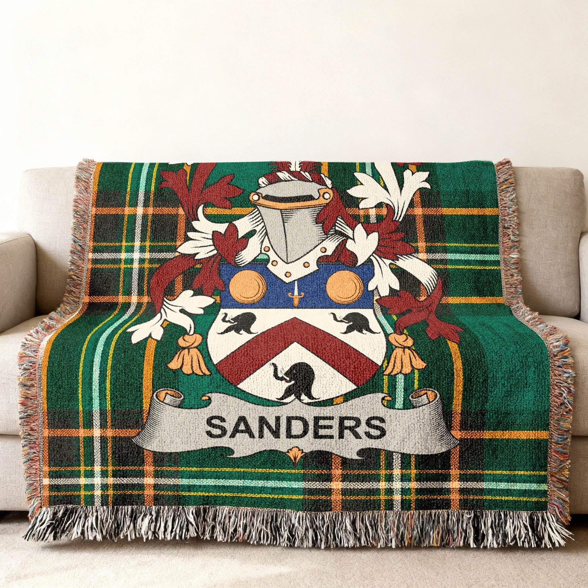 Green plaid throw blanket featuring the Sanders family crest with a shield and banner.