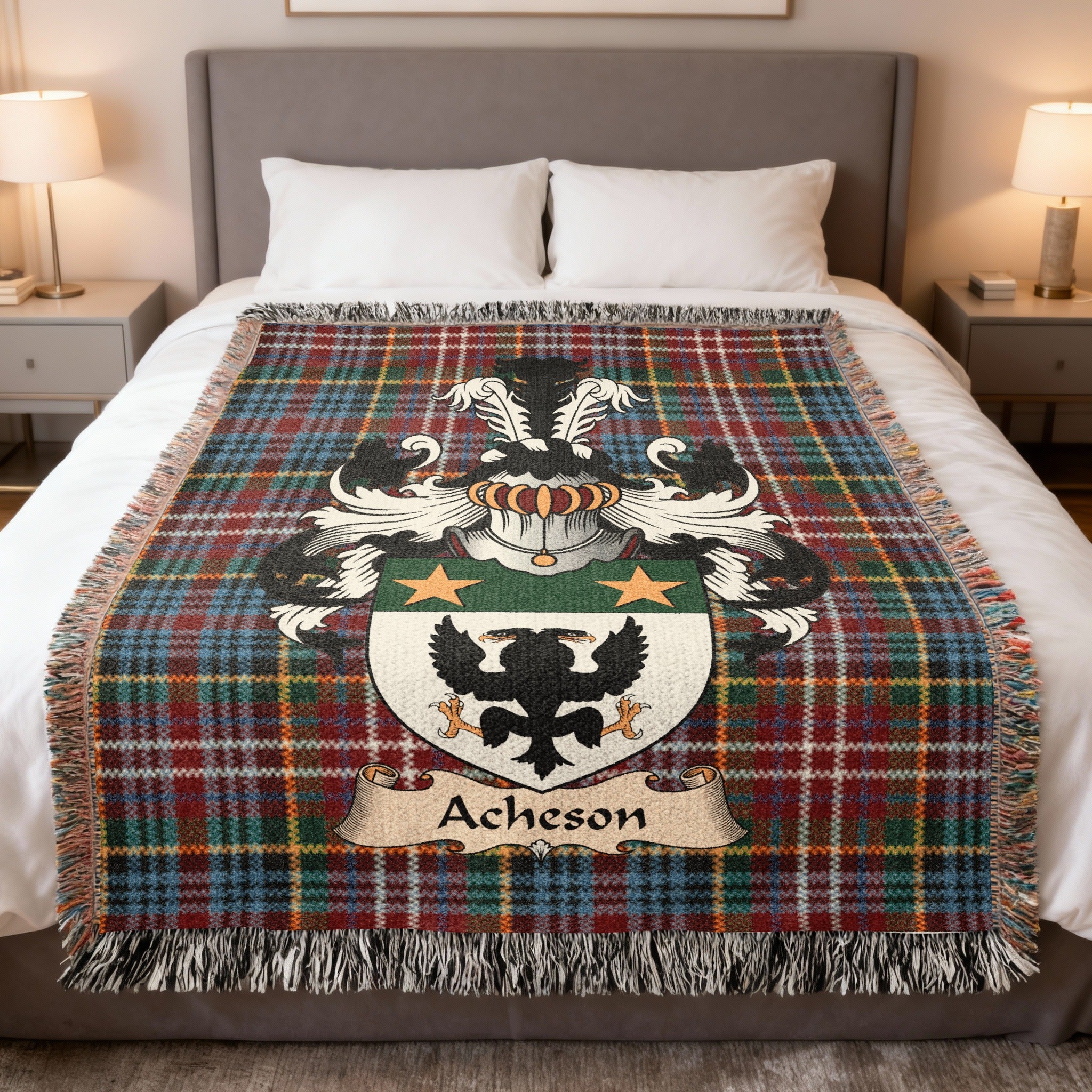 Acheson Scottish family crest woven blanket on a Caledonia tartan background, displayed on a bed