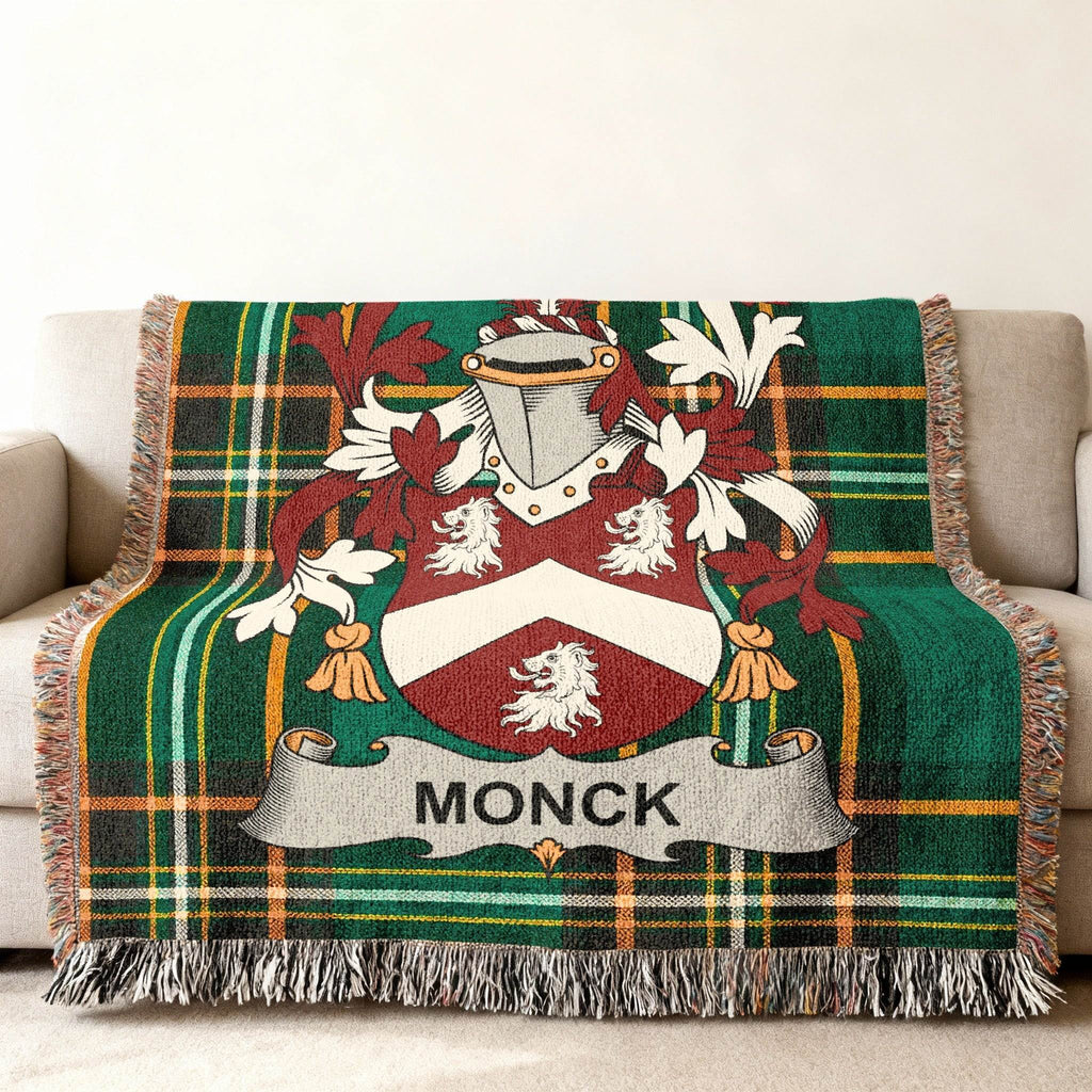 Monck family crest on a green and red plaid throw blanket draped on a sofa.