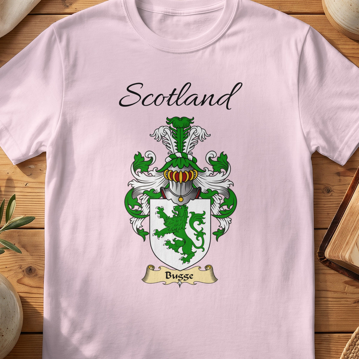Light Pink Bugge Scottish family shield T-shirt featuring a green lion on a white shield