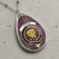 Little clan Scottish tartan necklace with clan crest and Magnum in Parvo motto on tartan background