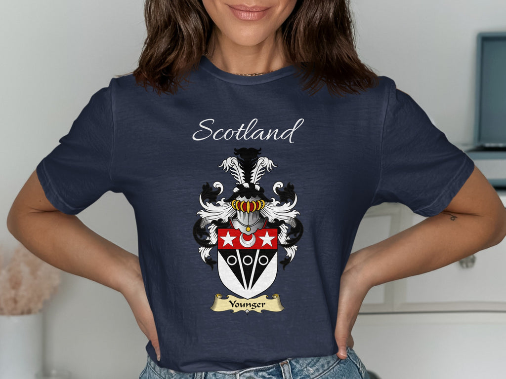 Model wearing the navy Younger family crest T-shirt featuring “Scotland” and the surname banner.