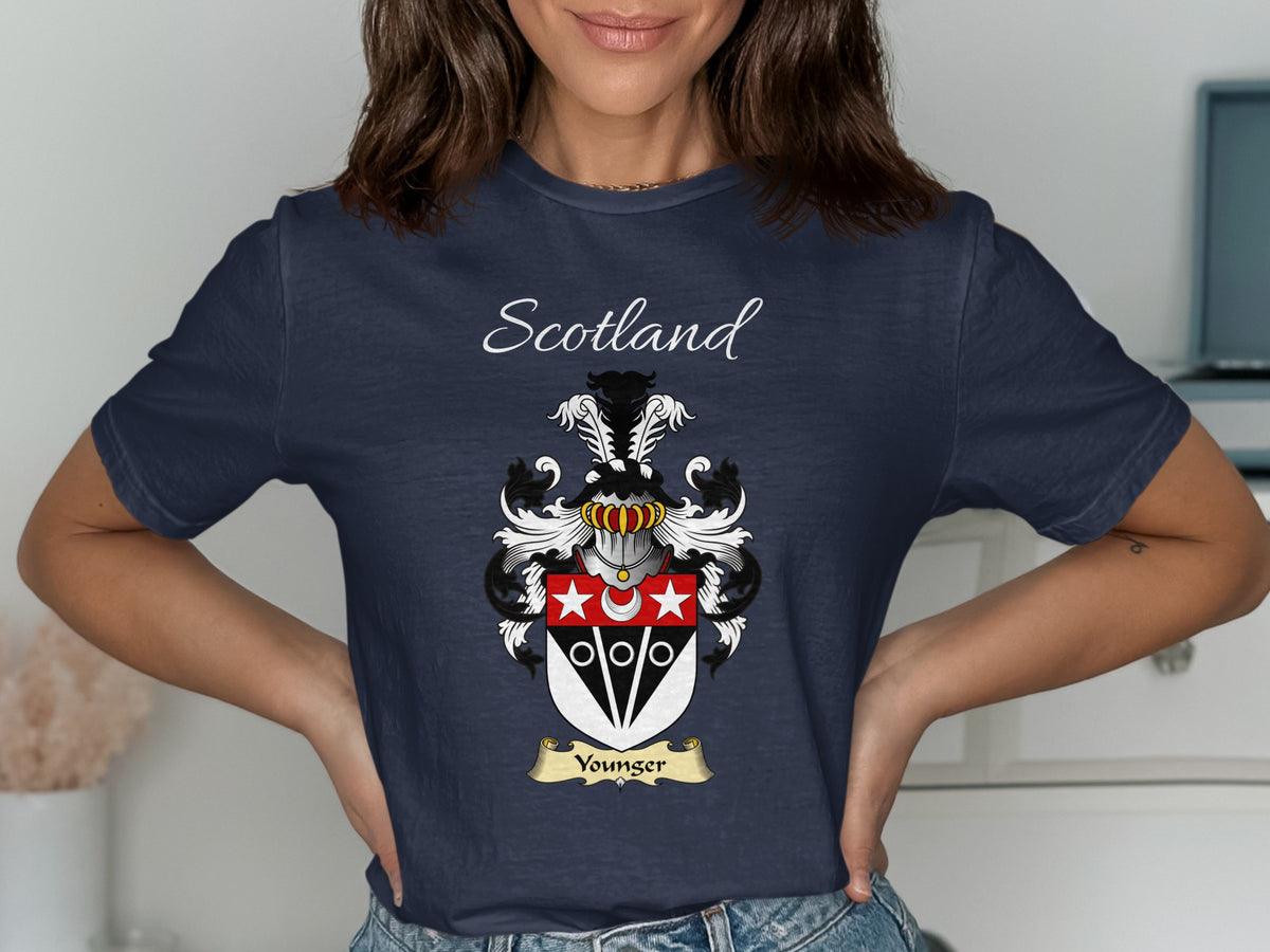Model wearing the navy Younger family crest T-shirt featuring “Scotland” and the surname banner.