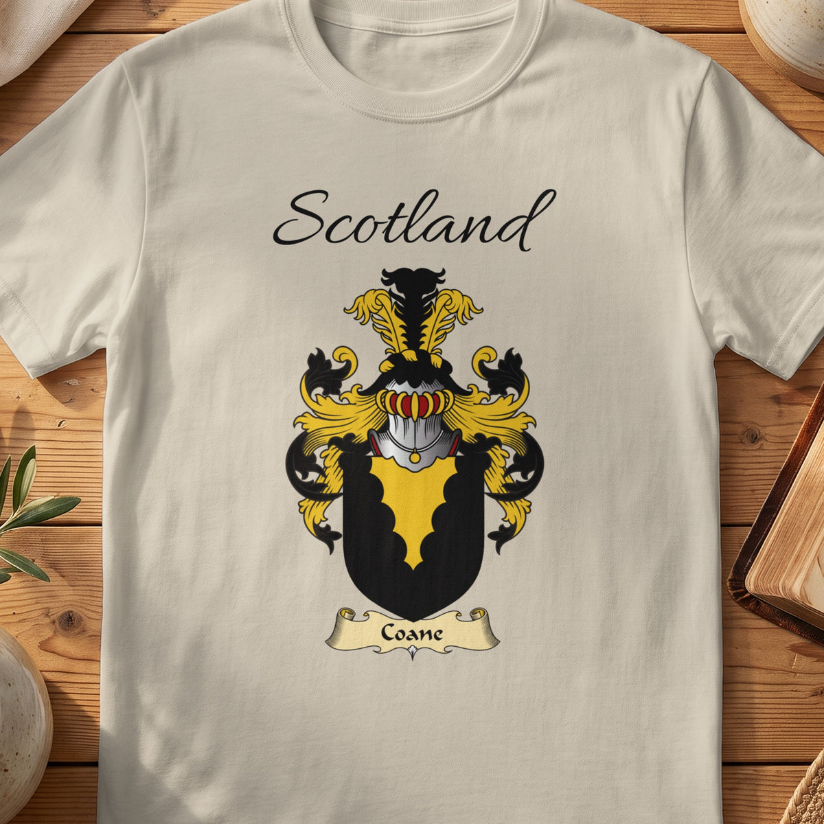 Sand Coane Scottish family shield T-shirt featuring a gold scalloped wedge on black