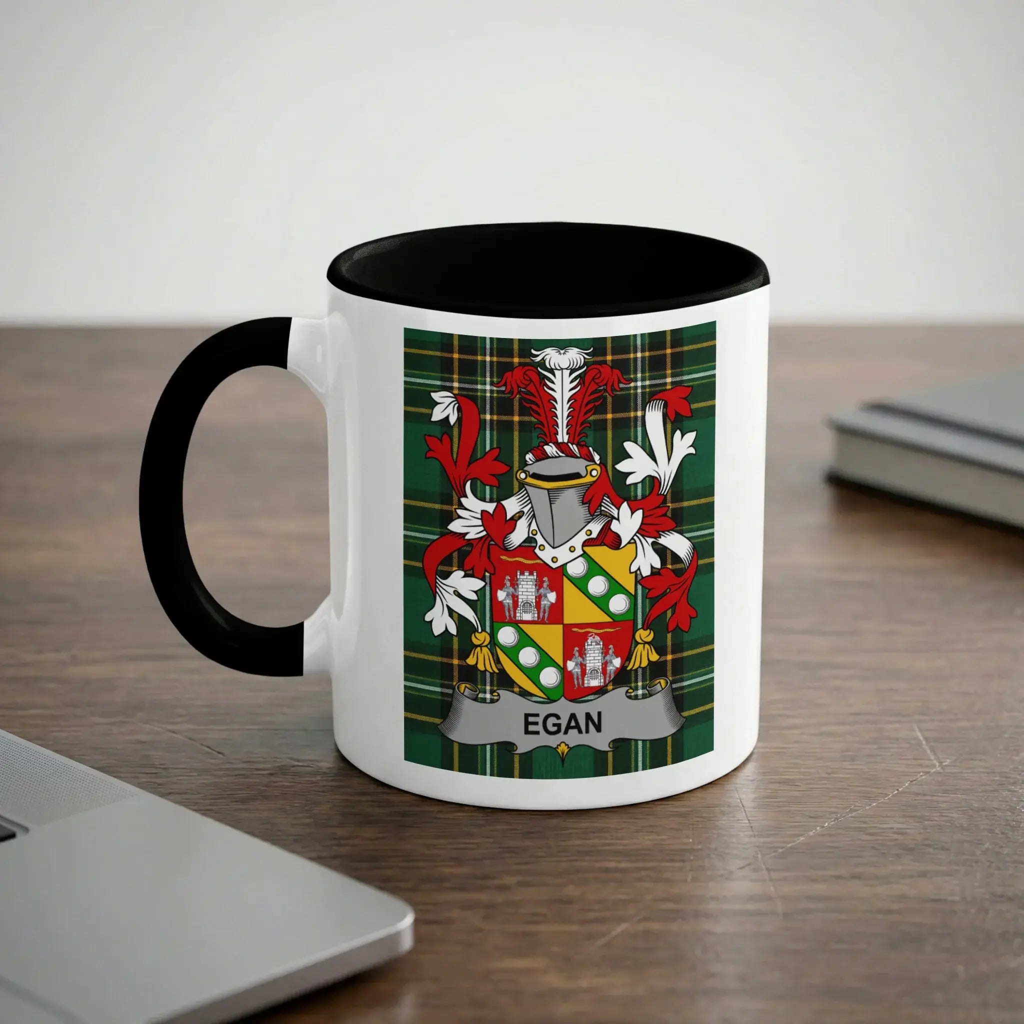 White mug with black handle featuring the Egan family crest on a tartan background.