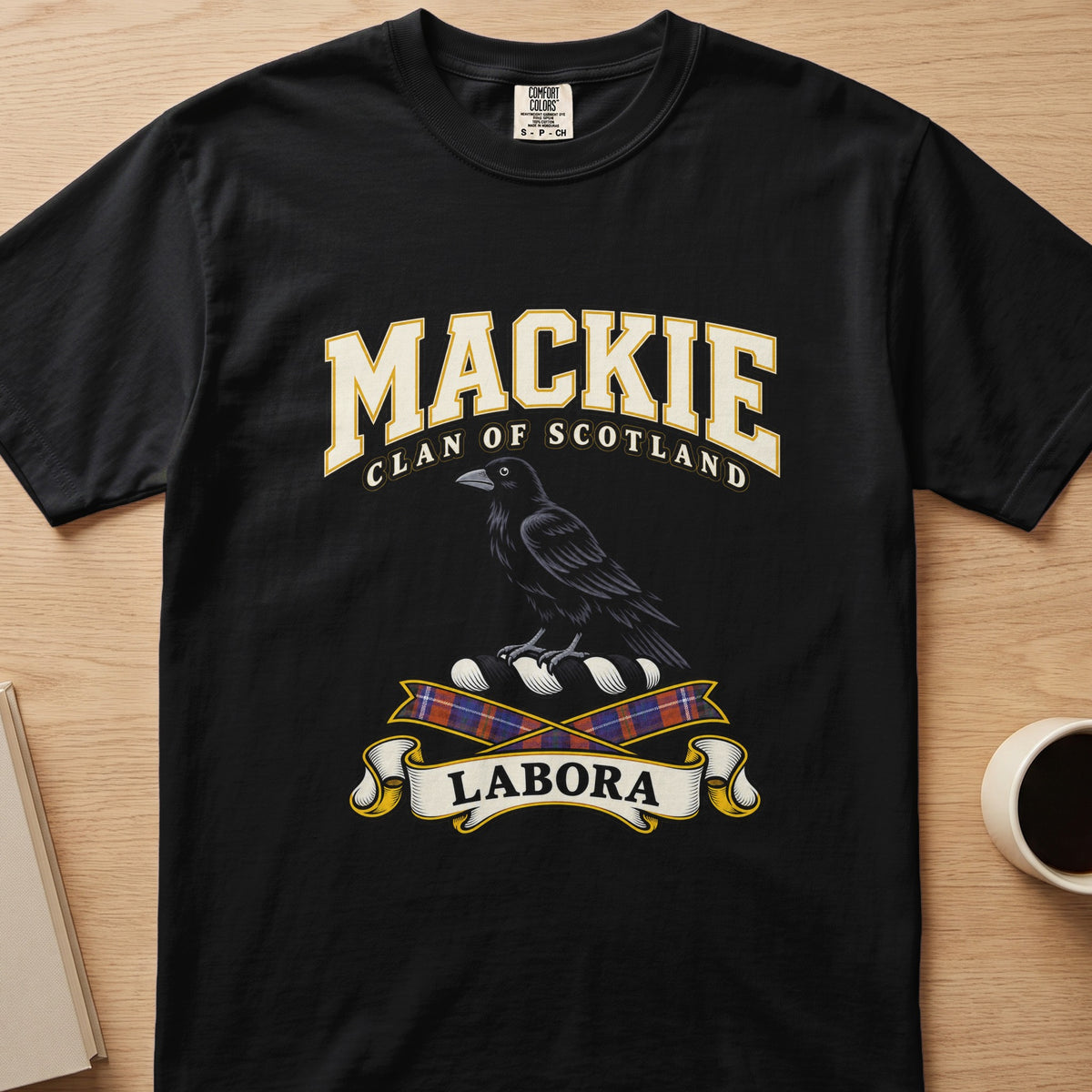 MacKie clan T-shirt in black, front view with black bird above tartan ribbons