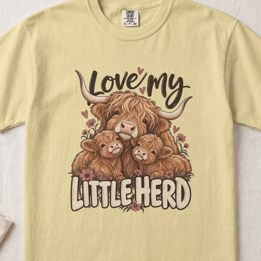 Love My Little Herd Highland cow design on a Butter Comfort Colors 1717 T-shirt, flat lay