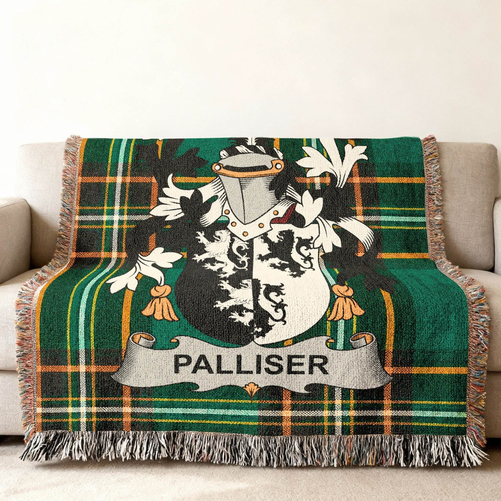 Woven throw blanket with green plaid and a Palliser family crest.