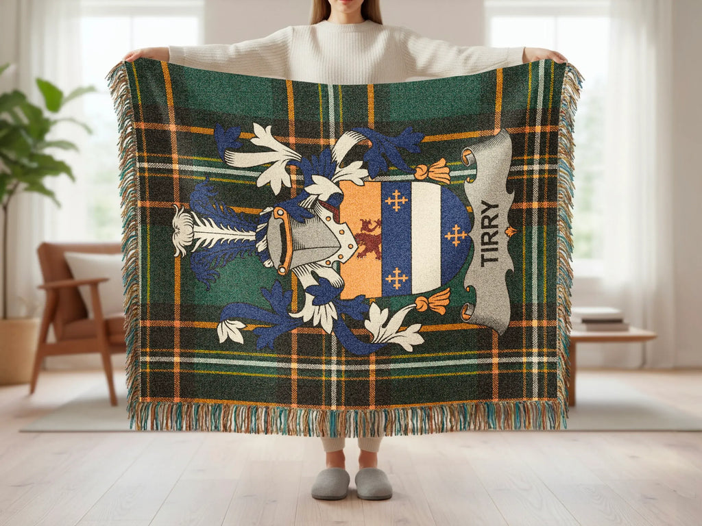 Tartan blanket with crest and "TIRRY" text, held by a person.