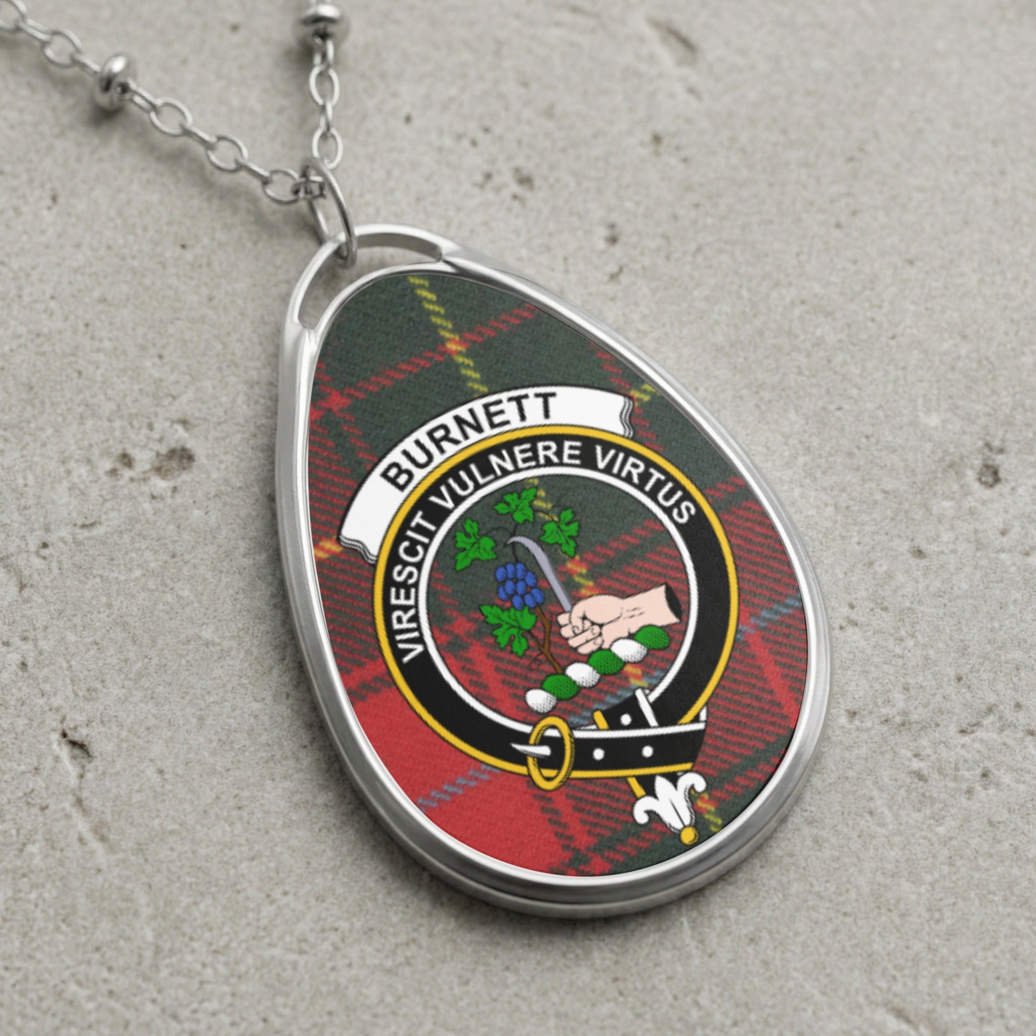 Burnett clan Scottish tartan necklace with clan crest on tartan background