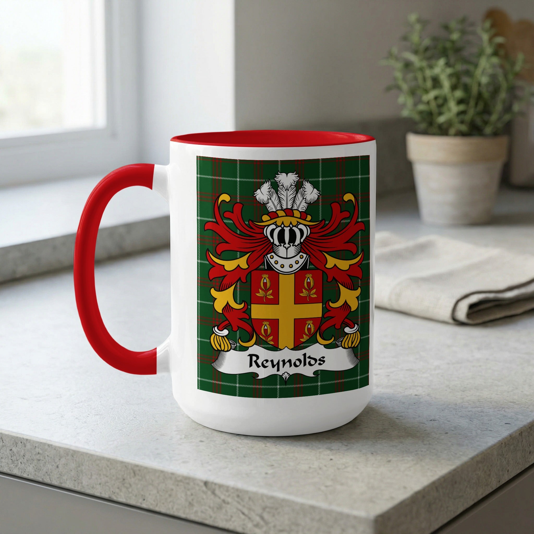 White mug with red handle and interior, featuring the Reynolds coat of arms.