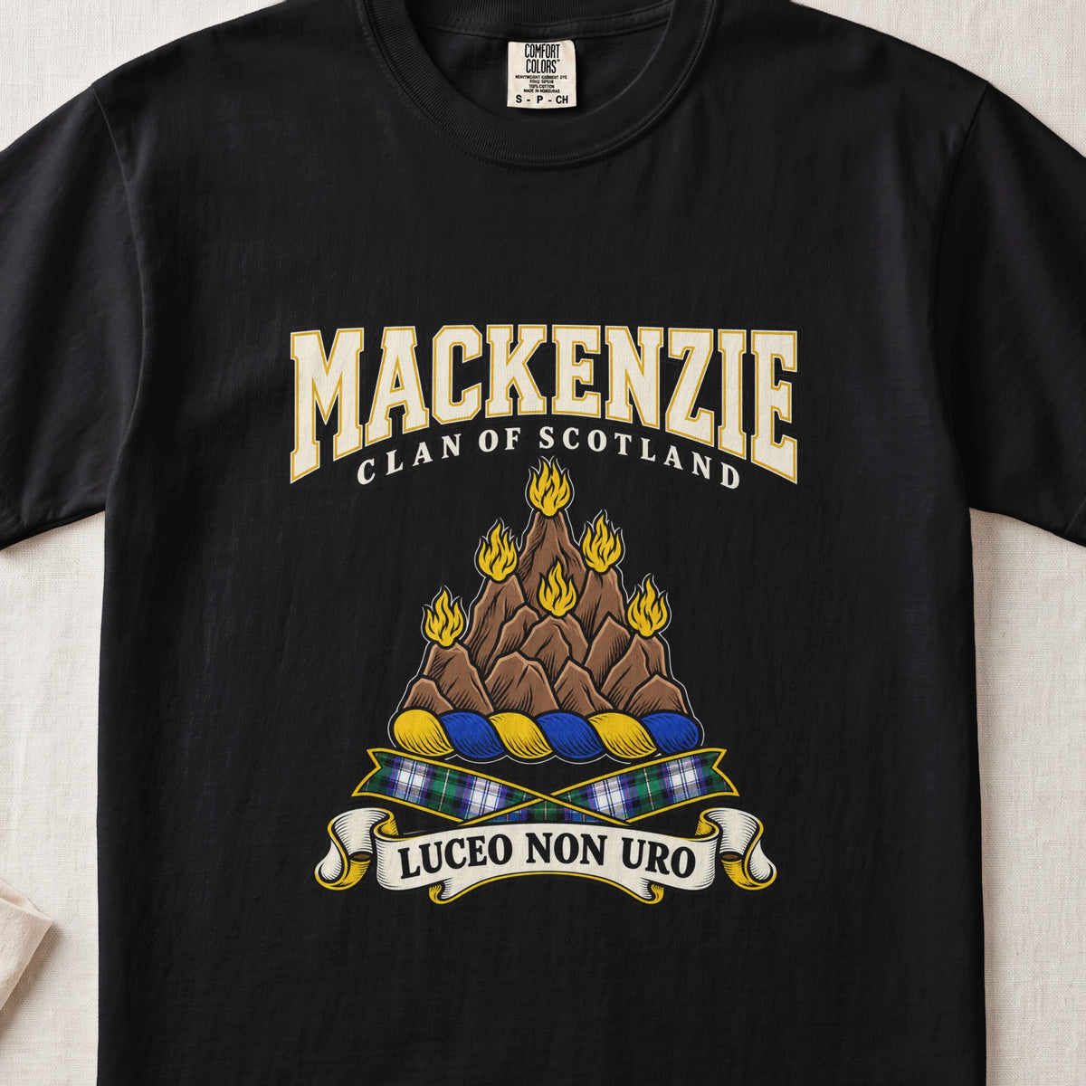 MacKenzie graphic T-shirt in Black, front flat lay showing varsity lettering and brown rocky mount with six gold flames.
