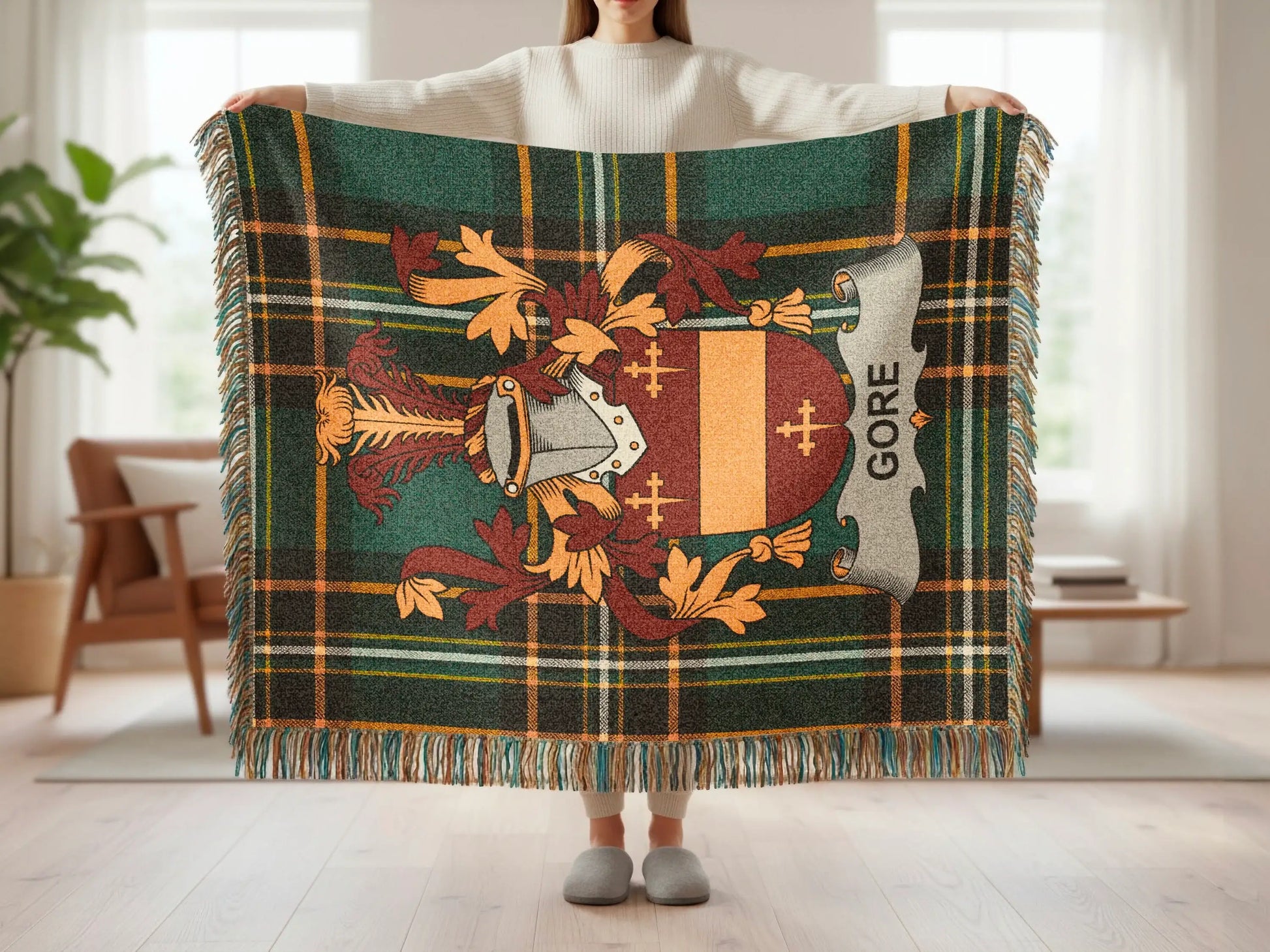 Green plaid blanket with brown and yellow stripes, featuring a crest with the name "Gore".