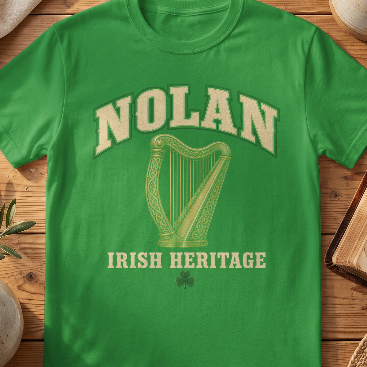 Nolan Irish harp T-shirt in Irish Green, with cream surname lettering, a gold-toned harp, green shamrock and “Irish Heritage” text.