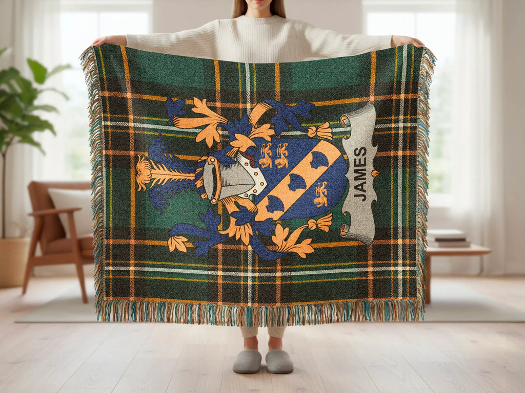 Green plaid throw blanket with a family crest and "JAMES" text.