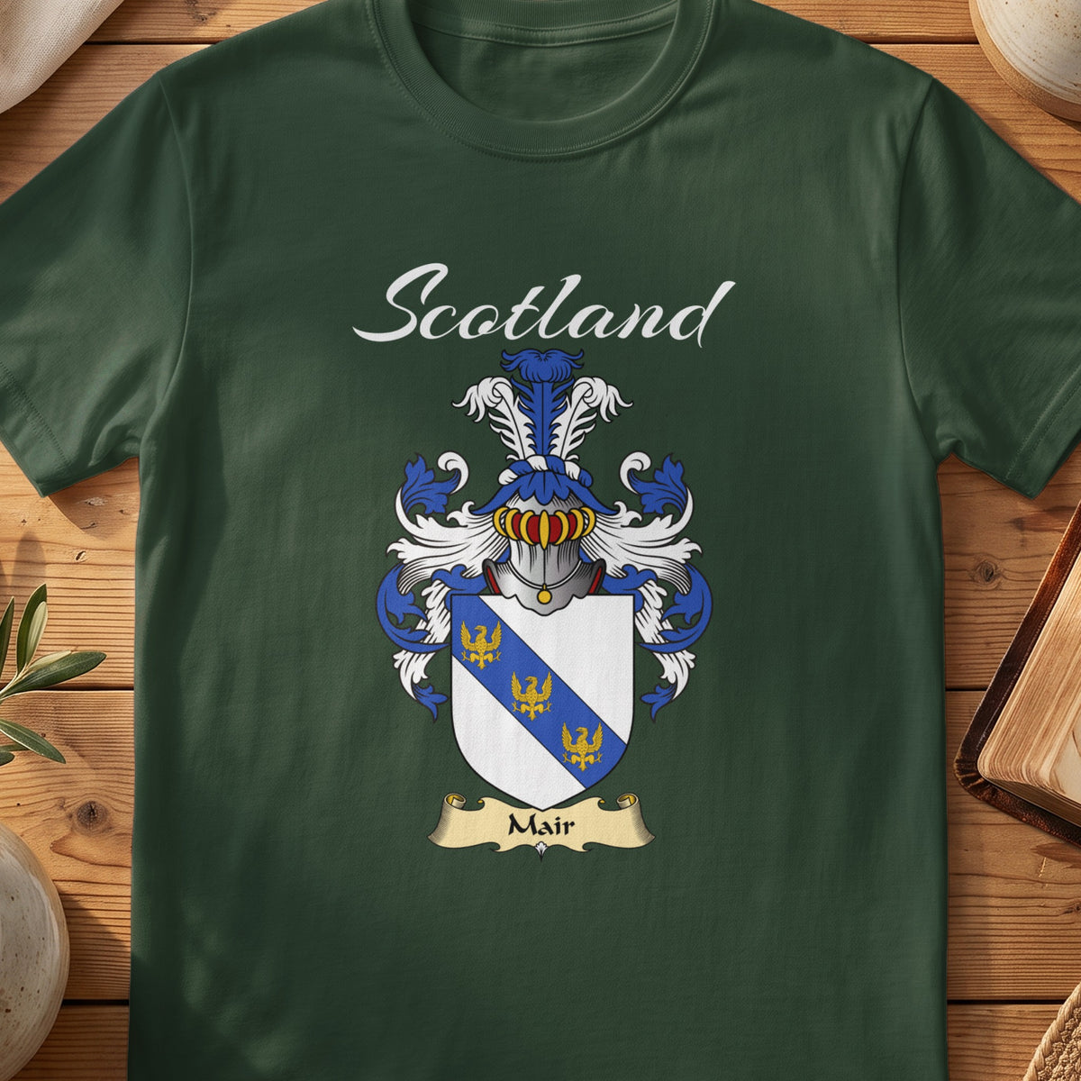 Forest Green Mair Scottish T-shirt featuring a blue diagonal band with small gold motifs